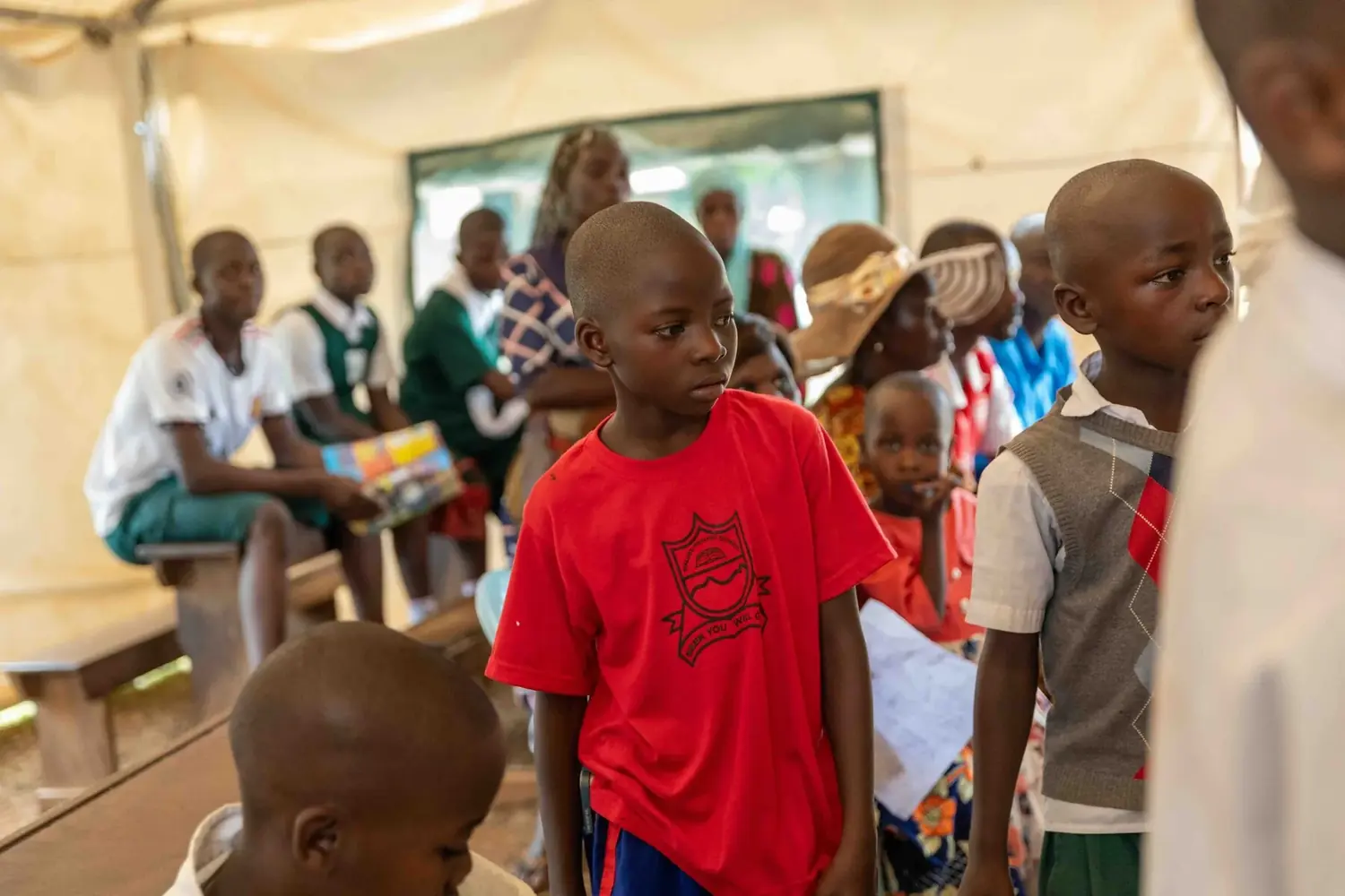 Pupils waiting at a Healing Wheels Uganda camp