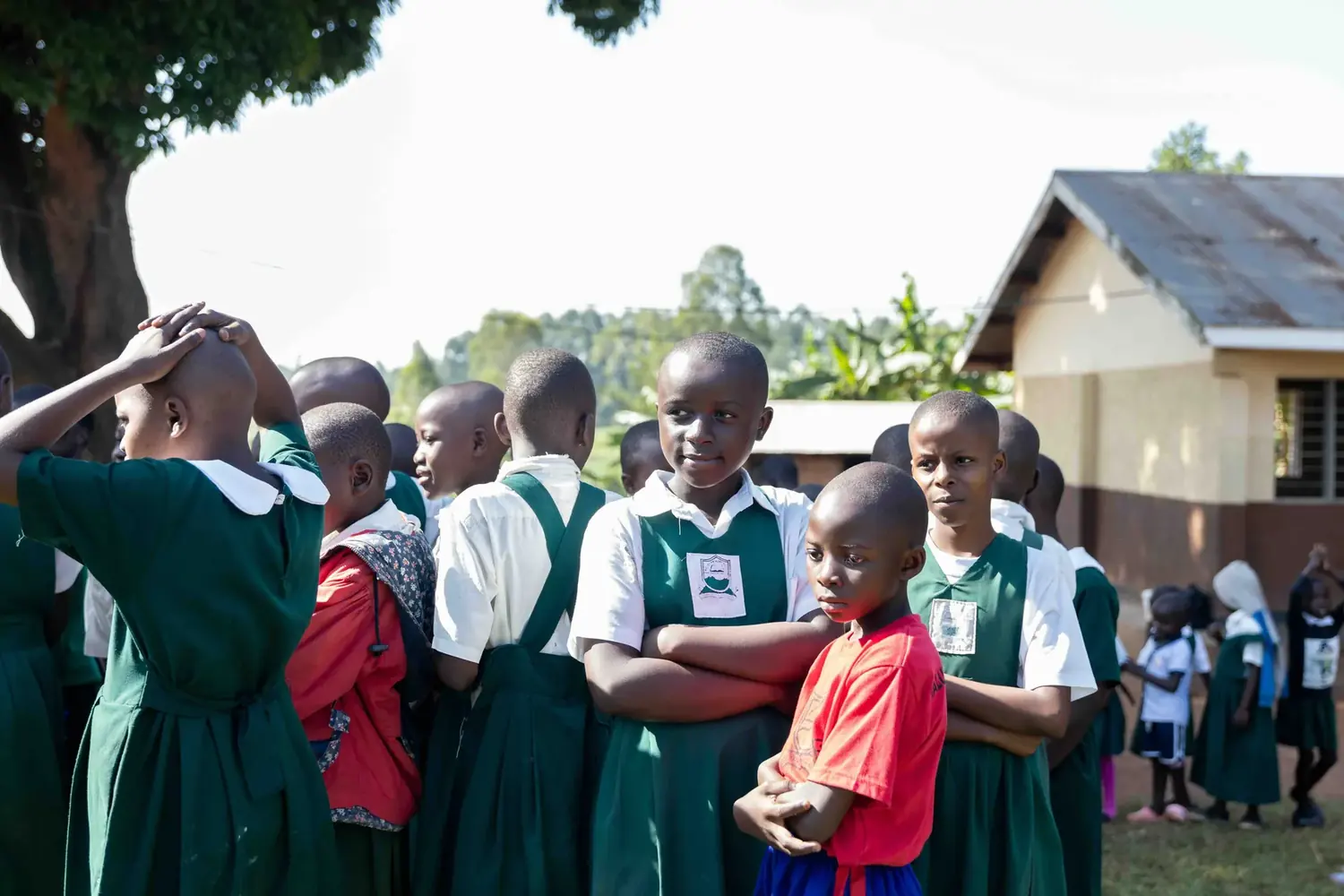 Pupils gathered outside a camp tent